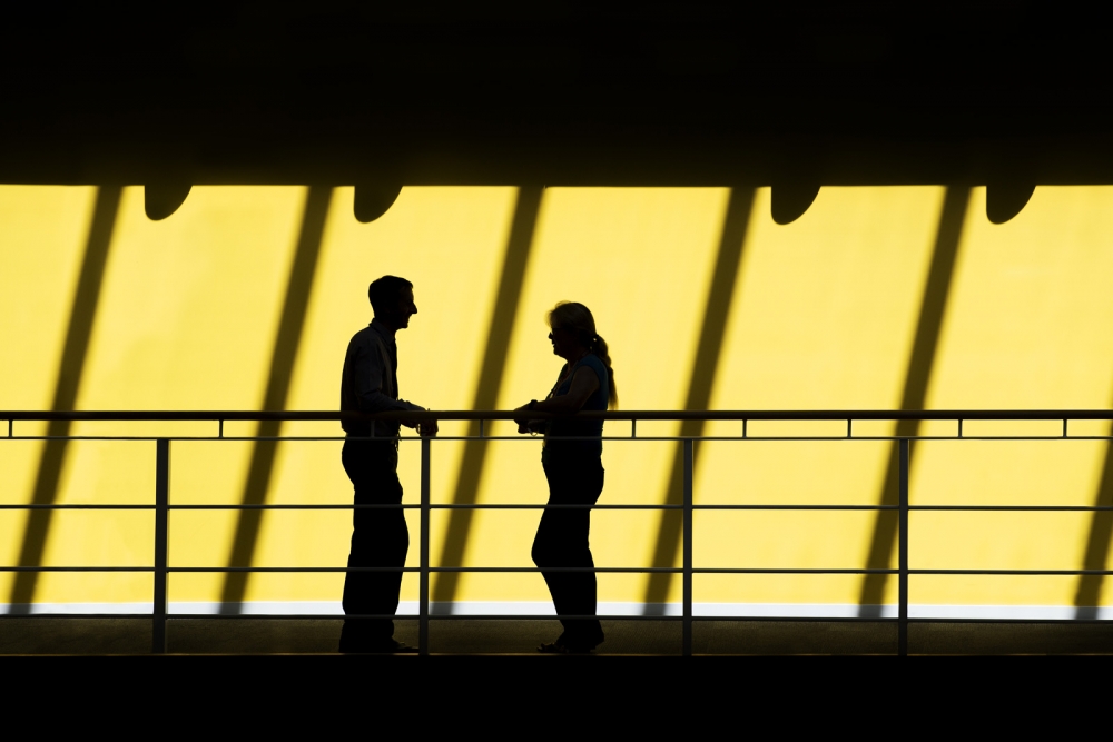 Silhouette of meeting by railings