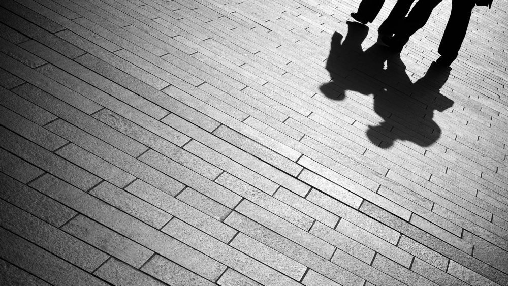 Shadows of people walking
