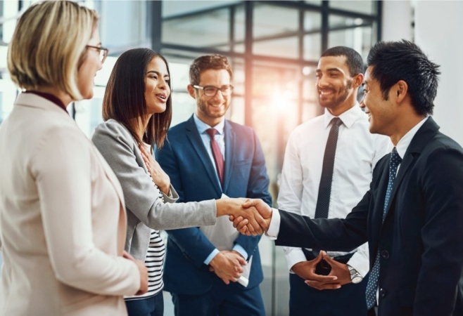 Group of men and women shaking hands