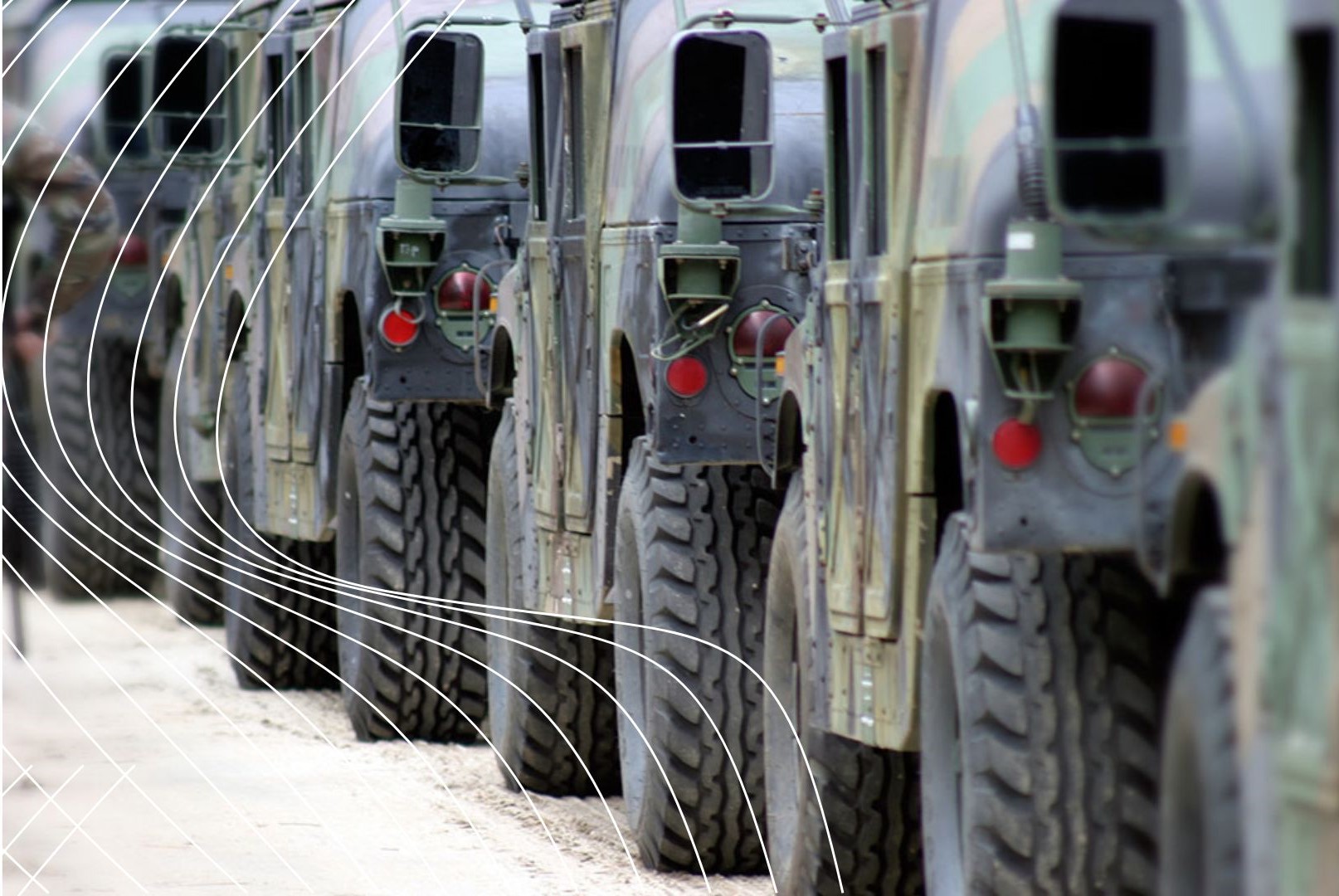 Camouflaged military Humvees parked in a row on a rugged outdoor terrain, with large tires and overlaid white curved graphics emphasizing motion or energy.