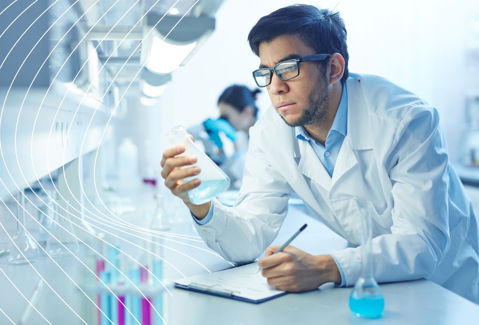 Materials scientist in a lab holding a glass container with blue liquid, writing on a clipboard, surrounded by beakers and flasks filled with blue substances.